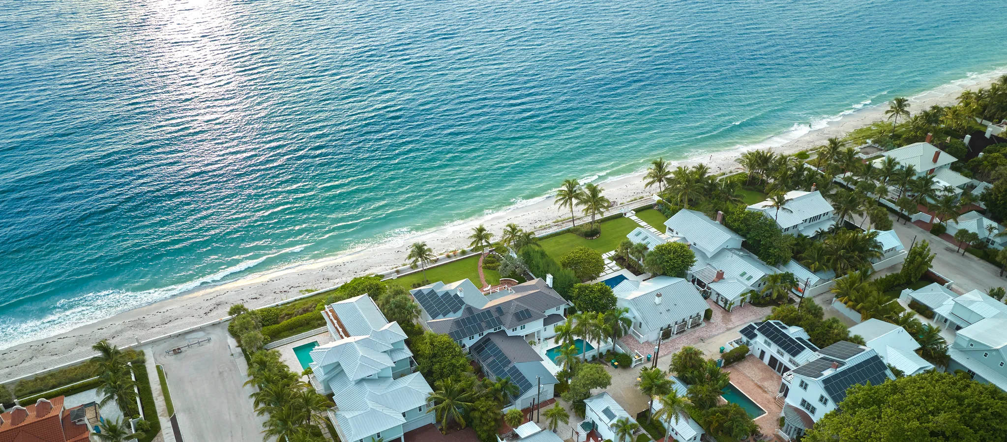 Aerial view of expensive residential houses in island small town in southwest Florida. American dream homes in US suburbs. Estate, wealth, property, U.S. and Florida themed stock photo.