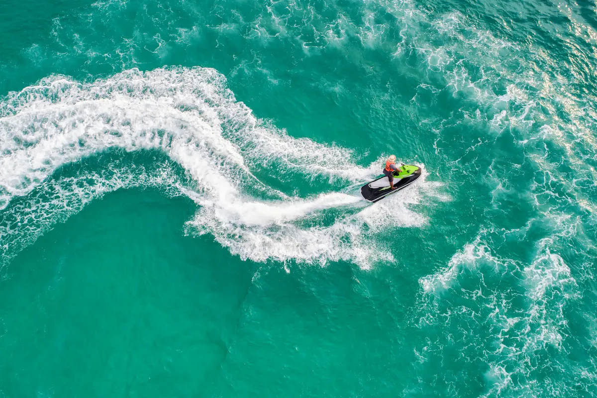 Aerial view of a jet ski at sea, tropical or Florida summer vacation or second home life style. Vacation, retirement or estate planning inspiration theme stock photo.